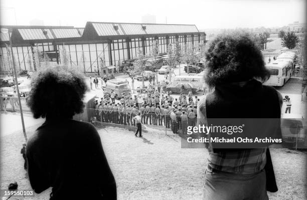 Spectators and cameramen watch as West German Police gather near the quarters of the Israili Olympic team where members of the Black September...