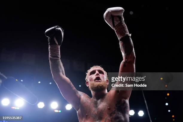 Jake Paul raises his arms in the air after his fight against Nate Diaz at American Airlines Center on August 05, 2023 in Dallas, Texas.
