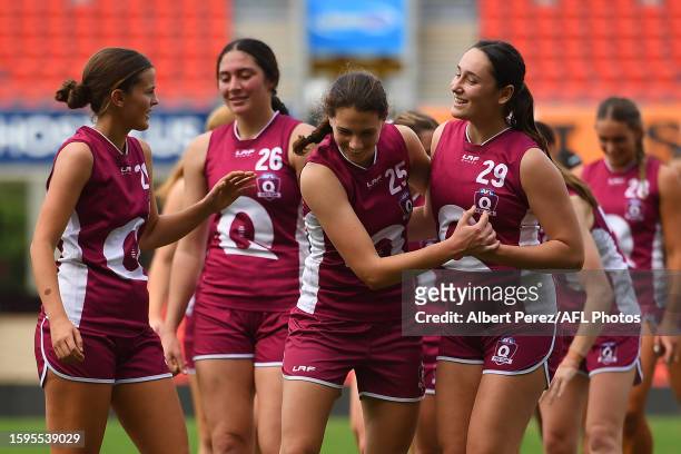 Mia Salisbury, Kiara Bischa and Ella Calleja of Queensland celebrate victory during the AFL National Championships U18 Girls match between Queensland...