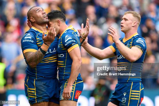 Junior Paulo of the Eels celebrates scoring a try with team mates during the round 23 NRL match between Parramatta Eels and St George Illawarra...