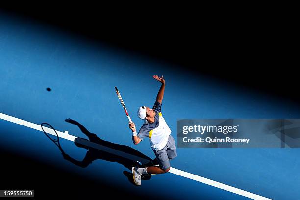 Tatsuma Ito of Japan serves in his second round match against Marcos Baghdatis of Cyprus during day three of the 2013 Australian Open at Melbourne...