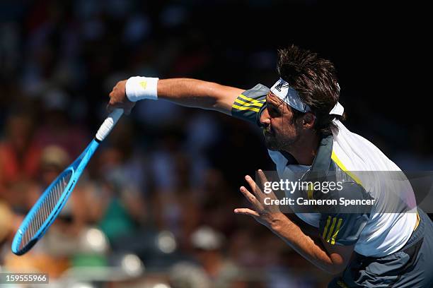 Marcos Baghdatis of Cyprus serves in his second round match against Tatsuma Ito of Japan during day three of the 2013 Australian Open at Melbourne...