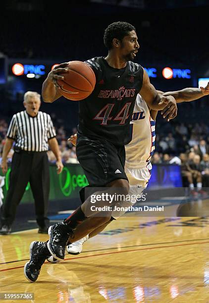 Jaquon Parker of the Cincinnati Bearcats moves past Worrel Clahar of the DePaul Blue Demons at Allstate Arena on January 15, 2013 in Rosemont,...