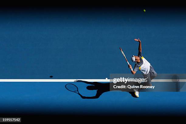 Tatsuma Ito of Japan serves in his second round match against Marcos Baghdatis of Cyprus during day three of the 2013 Australian Open at Melbourne...