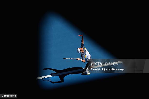 Tatsuma Ito of Japan serves in his second round match against Marcos Baghdatis of Cyprus during day three of the 2013 Australian Open at Melbourne...