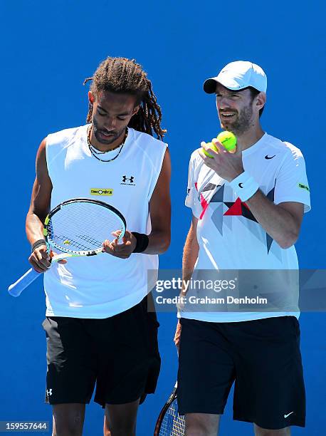 Dustin Brown of Germany talks tactics with Christopher Kas of Germany in their first round doubles match against Marc Lopez of Spain and Marcel...