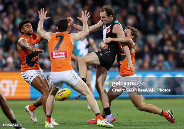 Jeremy Finlayson of the Power under pressure from Toby McMullin of the Giants, Lachie Ash of the Giants and Connor Idun of the Giants during the 2023...