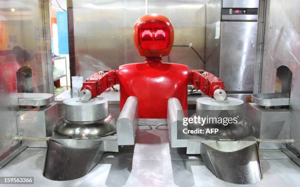 Robot cooks in a robot-themed restaurant in Harbin, northeast China's Heilongjiang province on January 16, 2013. Twenty robots perform a variety of...