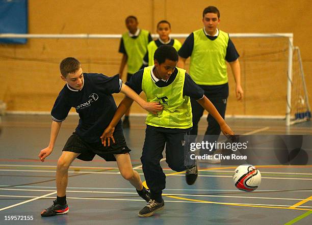 Local school children participate in a football match under the coaching of Andre Villa Boas during the Laureus Urban Research report launch on...