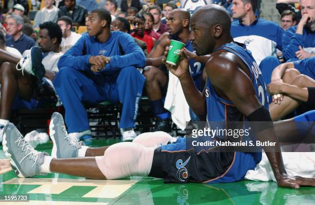 Michael Jordan of the Washington Wizards sits on the sideline, icing his knees, during the NBA preseason game against the Boston Celtics at Fleet...