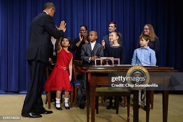 President Barack Obama gives high-fives to children who wrote letters to the White House about gun violence, Hinna Zeejah, Taejah Goode, Julia Stokes...