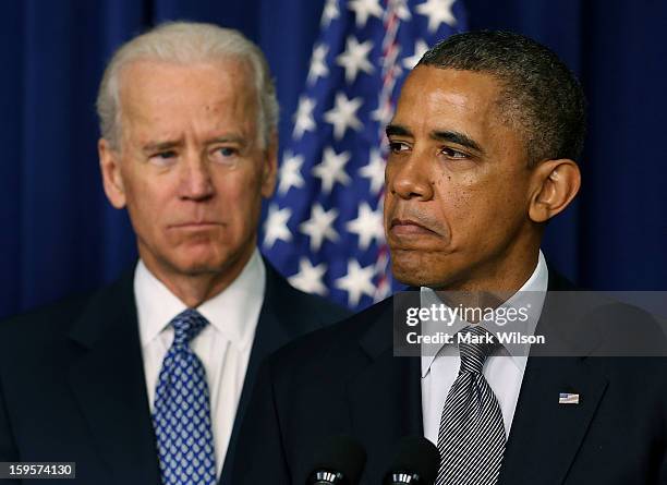 President Barack Obama , is flanked by Vice President Joe Biden before signing an executive order designed to tackle gun control, on January 16, 2012...