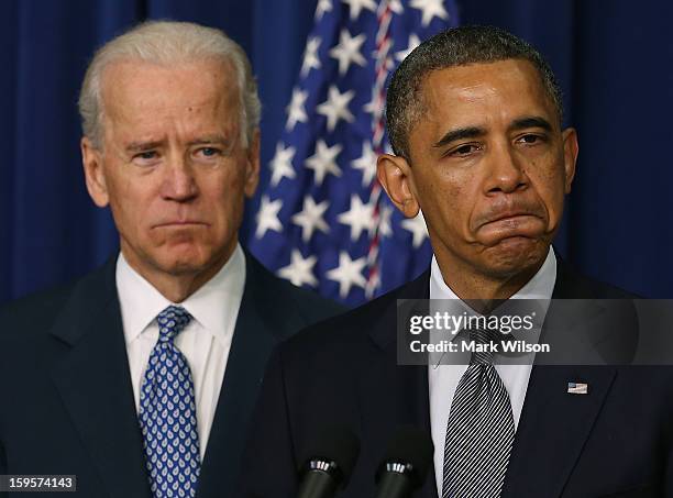 President Barack Obama , is flanked by Vice President Joe Biden before signing an executive order designed to tackle gun control, on January 16, 2012...