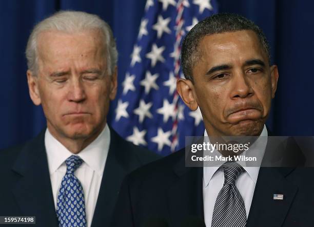 President Barack Obama , is flanked by Vice President Joe Biden before signing an executive order designed to tackle gun control, on January 16, 2012...