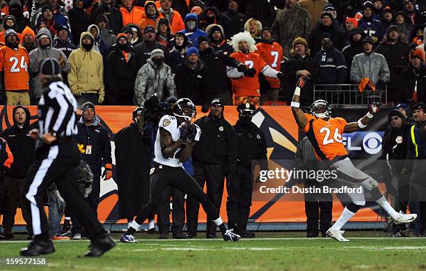 Jacoby Jones of the Baltimore Ravens catches a 70-yard touchdown reception in the fourth quarter against Rahim Moore of the Denver Broncos during the...