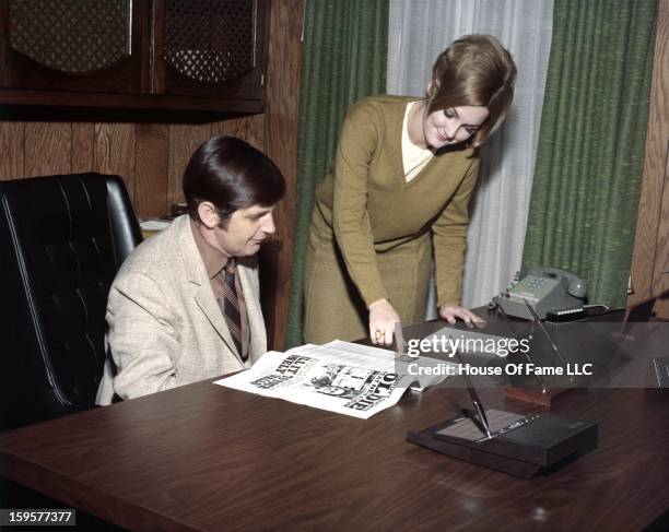 Songwriter and producer Rick Hall chats with secretary Carol Little in his office at FAME Studios in 1968 in Muscle Shoals, Alabama.