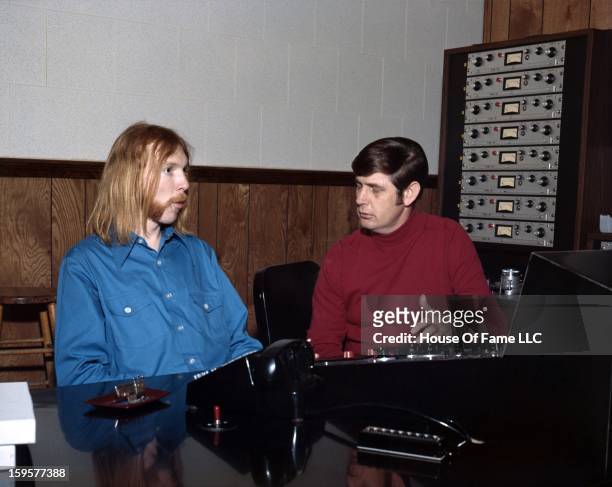 Songwriter and producer Rick Hall and session guitarist Duane Allman at the mixing board at FAME Studios in 1968 in Muscle Shoals, Alabama.