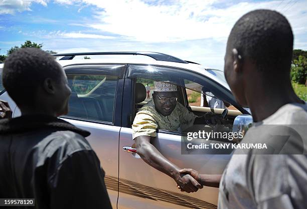 President Barack Obama's Kenyan half brother, Malik Obama greets some of his supporters on January 16, 2013 during a campaign rally near Nyang'oma in...