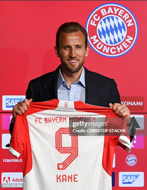 Bayern Munich's English forward Harry Kane poses with his jersey during a press conference on his presentation after signing a four-years deal with...