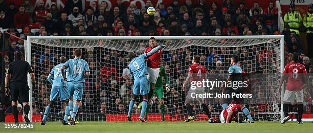 Chris Smalling of Manchester United in action with Carlton Cole of West Ham United during the FA Cup Third Round Replay match between Manchester...