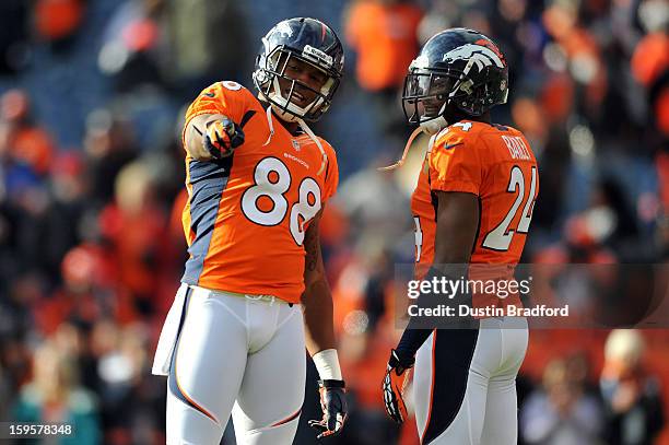 Demaryius Thomas and Champ Bailey of the Denver Broncos talk on the field against the Baltimore Ravens during the AFC Divisional Playoff Game at...