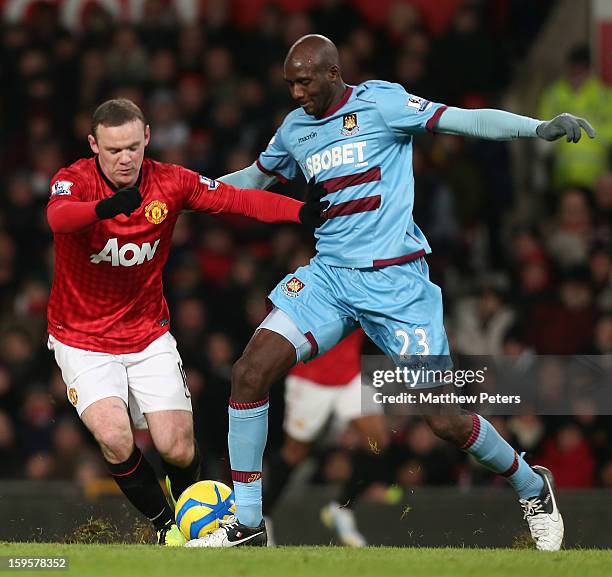 Wayne Rooney of Manchester United in action with Alou Diarra of West Ham United during the FA Cup Third Round Replay between Manchester United and...