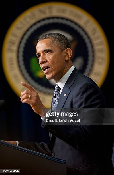 President Barack Obama signs executive orders designed to reduce gun violence in the United States in the Eisenhower Executive Building on January...