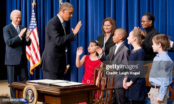 President Barack Obama and Vice President Joe Biden greet children who wrote letters to the White House expressing concern about gun violence before...