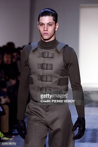 Model displays a creation by Japanese-Italian designer Nicola Formichetti for the label Mugler during the men's Fall-Winter 2013-2014 collection...