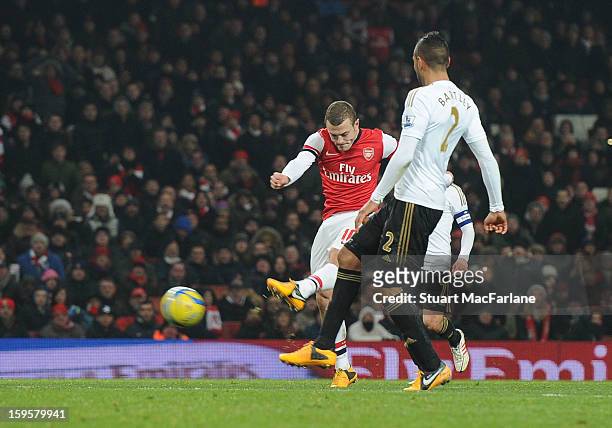 Jack Wilshere shoots past Swansea City goalkeeper Michel Vorm to score the Arsenal goal during the FA Cup Third Round Replay match between Arsenal...
