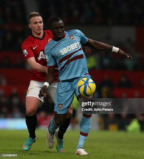 Alexander Buttner of Manchester United in action with Mohamed Diame of West Ham United during the FA Cup Third Round Replay match between Manchester...