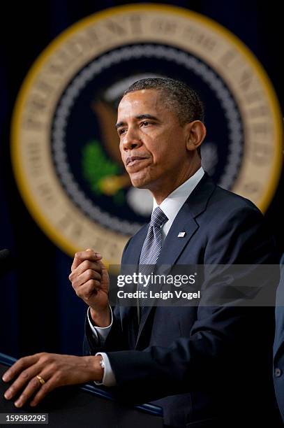 President Barack Obama signs executive orders designed to reduce gun violence in the United States in the Eisenhower Executive Building on January...