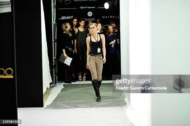 Model prepares backstage ahead of the Agne Kuzmickaite, Igrida Zabere, Kaetlin Kaljuvee Autumn/Winter 2013/14 fashion show during Mercedes-Benz...