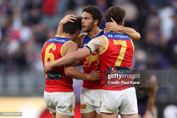 Hugh McCluggage, Cam Rayner and Jarrod Berry of the Lions celebrate winning the round 21 AFL match between Fremantle Dockers and Brisbane Lions at...