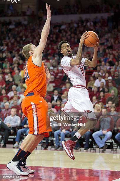 Rashad Madden of the Arkansas Razorbacks goes up for a rebound past Rob Chubb of the Auburn Tigers at Bud Walton Arena on January 16, 2013 in...