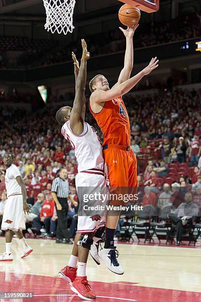 Rob Chubb of the Auburn Tigers goes up for a basket against Marshawn Powell of the Arkansas Razorbacks at Bud Walton Arena on January 16, 2013 in...