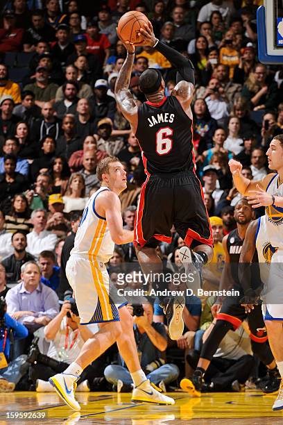 LeBron James of the Miami Heat makes a shot, passing the 20,000 point career milestone, against the Golden State Warriors on January 16, 2013 at...