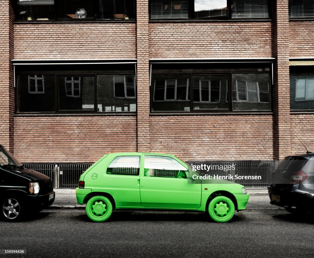 Green car, sustainable energy. (By sidewalk)