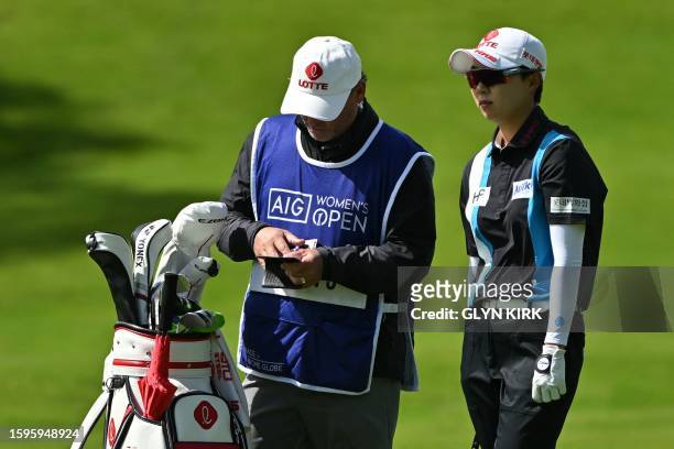 South Korea's Kim Hyo-joo talks to her caddie on the 1st fairway on day 4 of the 2023 Women's British Open Golf Championship at Walton Heath Golf...
