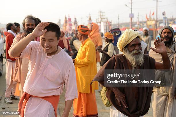 Devotees dance before they leave for a dip at Sangam, the confluence of the Rivers Ganges, Yamuna and mythical Saraswati.