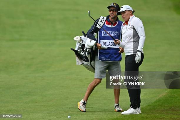 France's Perrine Delacour talks with her caddie before playing a shot from the 1st fairway on day 4 of the 2023 Women's British Open Golf...