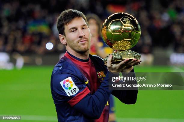 Lionel Messi of Barcelona FC offers his 4th ballon d'or to the audience prior to the Copa del Rey Quarter Final match between Barcelona FC and Malaga...