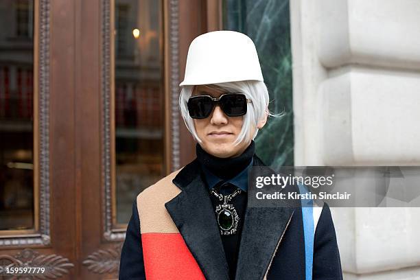 Masahiro Murase contributing fashion editor, GQ Japan wearing a Lanvin hat, and sweater, celine jacket and Givenchy sunglasses on day 2 of London...