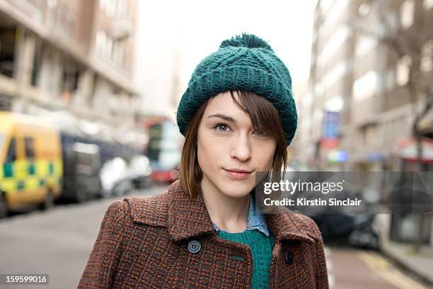 Ella Catliff blogger wearing a whistles coat and jumper, Topshop dress and hat on day 2 of London Mens Fashion Week Autumn/Winter 2013, on January...