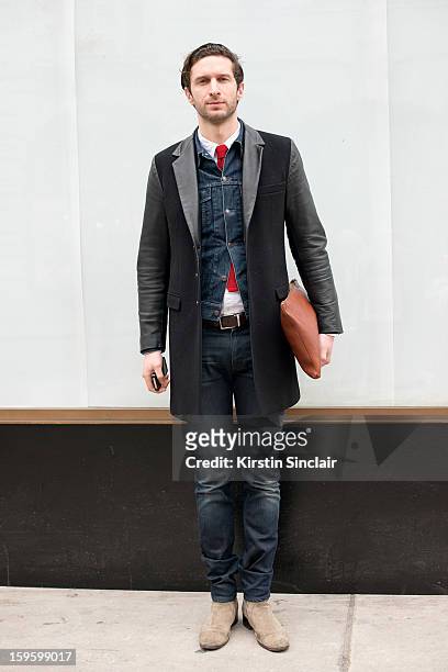 Jonathan Heaf fashion director at GQ wearing Dior shoes, Acne jeans, Versace for H and M leather jacket, Hackett clutch bag, Uniqlo denim jacket,...