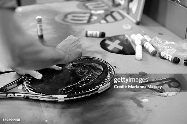 Freshly strung racquets are imprinted with sponsor logos in the stringers' hut at the 2013 Australian Open at Melbourne Park on January 17, 2013 in...