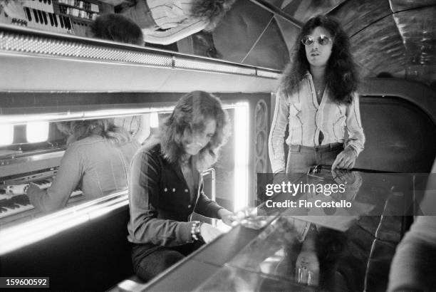 1st NOVEMBER: Singer David Coverdale and bassist Glenn Hughes from Deep Purple posed at a piano on board the Starship Boeing 720 Aircraft during the...