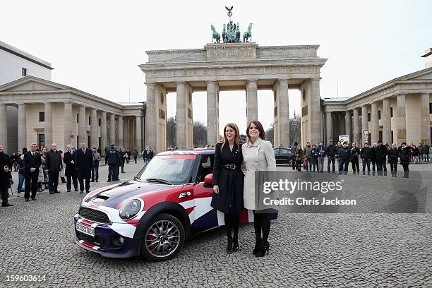 Princess Beatrice and Princess Eugenie pose next to a Mini in front of Brandenburg Gate as they promote the GREAT initiative on January 17, 2013 in...