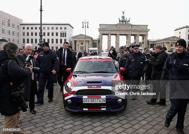 Princess Beatrice and Princess Eugenie drive a Mini in front of Brandenburg Gate as they promote the GREAT initiative on January 17, 2013 in Berlin,...