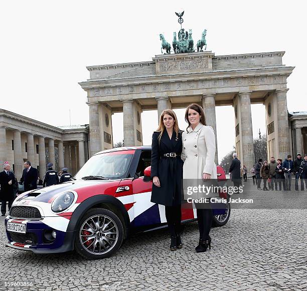 Princess Beatrice and Princess Eugenie pose next to a Mini in front of Brandenburg Gate as they promote the GREAT initiative on January 17, 2013 in...